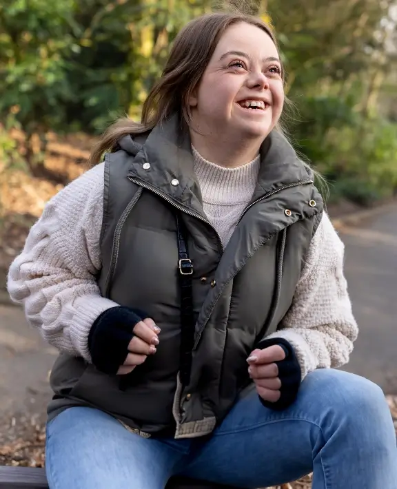 A smiling teenager in a forest