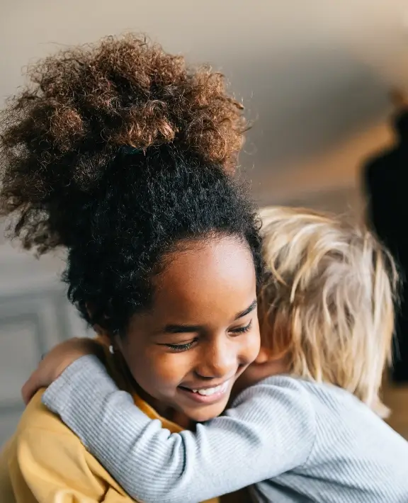 Two children hugging